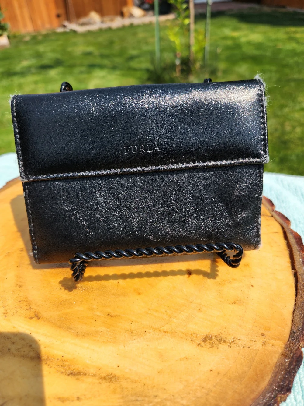 Authentic Furla trifold Compact wallet crafted from smooth black leather.
